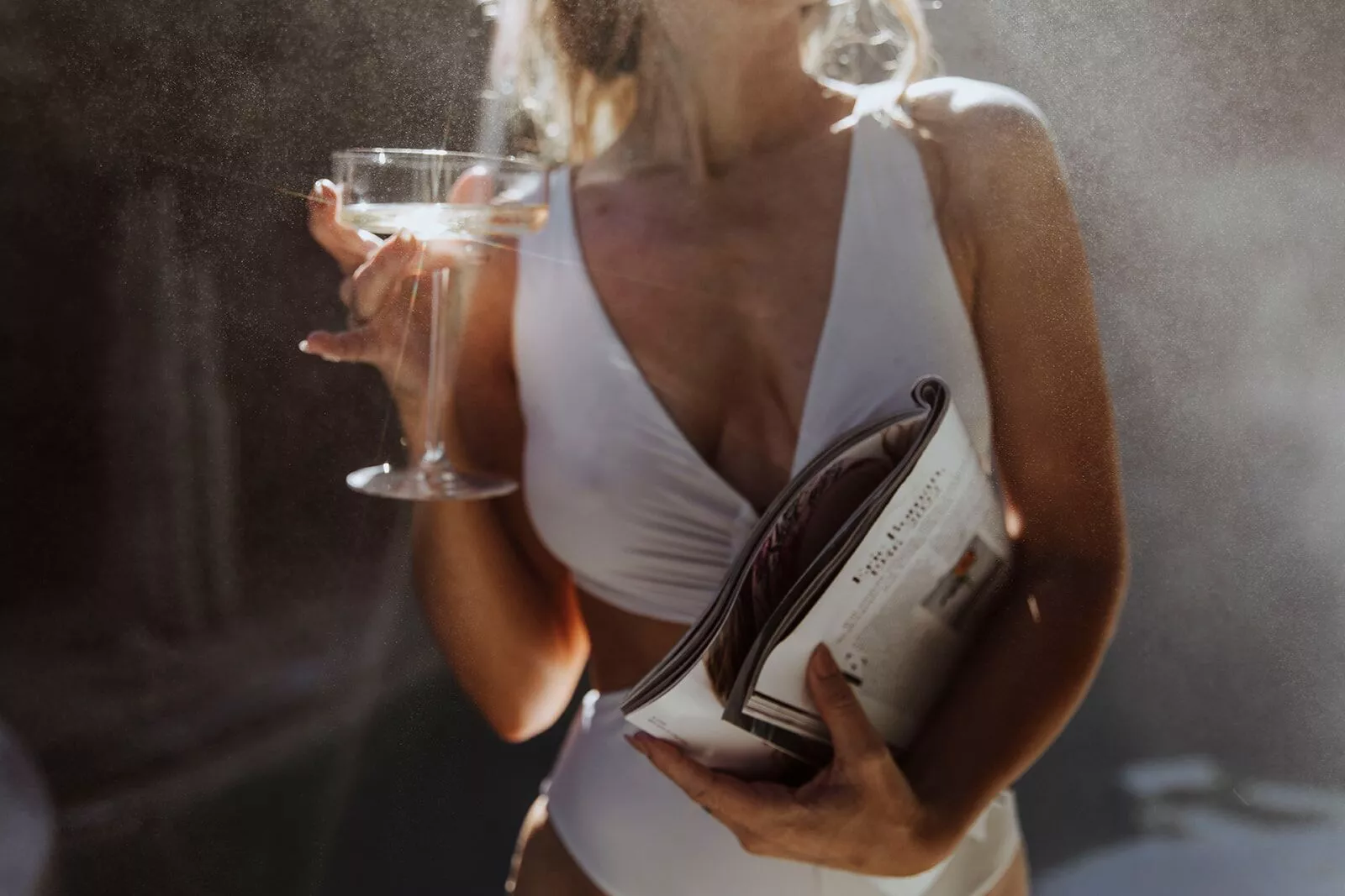 Portrait of a beautiful lady holding glass of drink and newspaper | Skyler Soares Skin Clinic in Scottsdale, AZ
