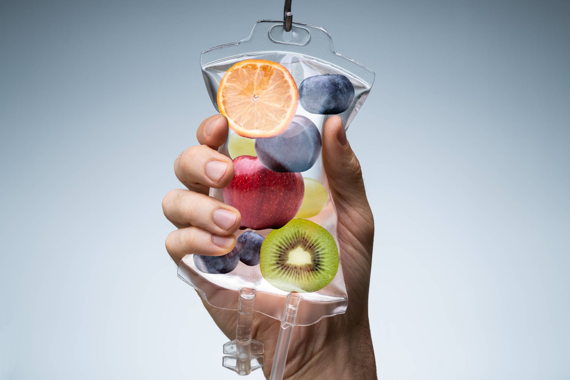 Portrait of a hand holding half cut fruits bag | Vitamin B12 Shots | Skyler Soares Skin Clinic